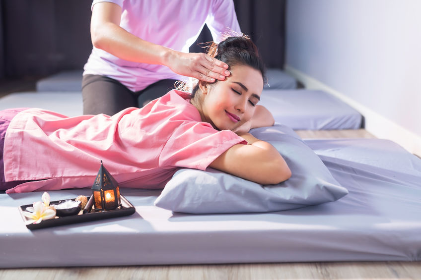 Thai massage to happy Asian woman